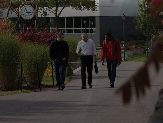 three men walking along a path