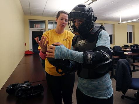 Campus Safety RAD training instructor with student in padded suit