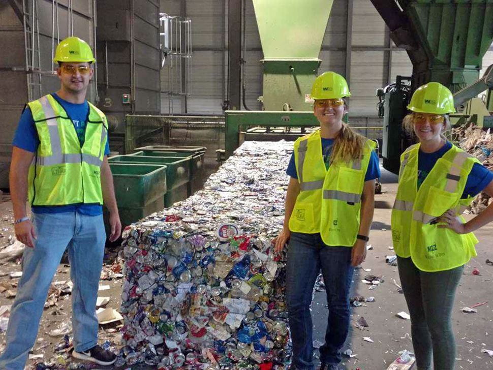 Three individuals in reflective gear at the WM Recycling facility