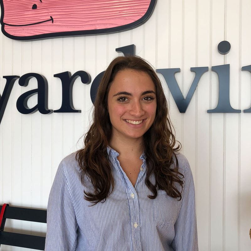 Sydney Sheehan in front of the Vineyard Vines signage