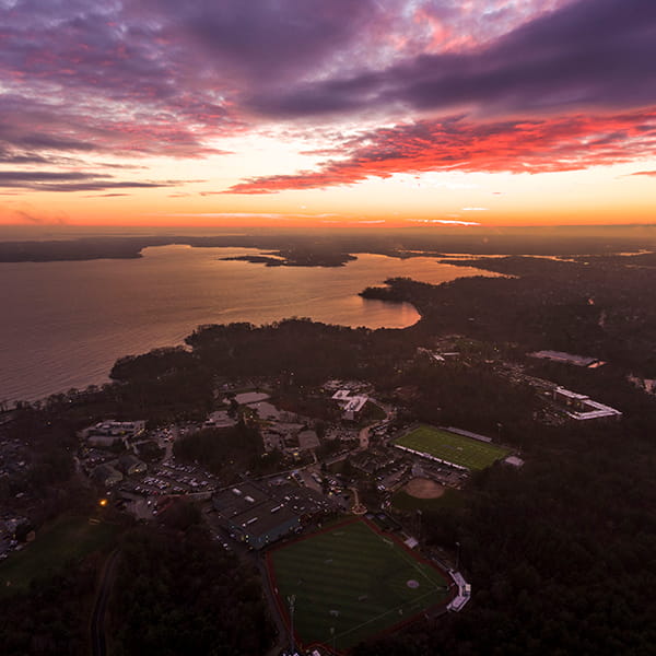 aerial shot of campus with ocean view during sunrise/sunset