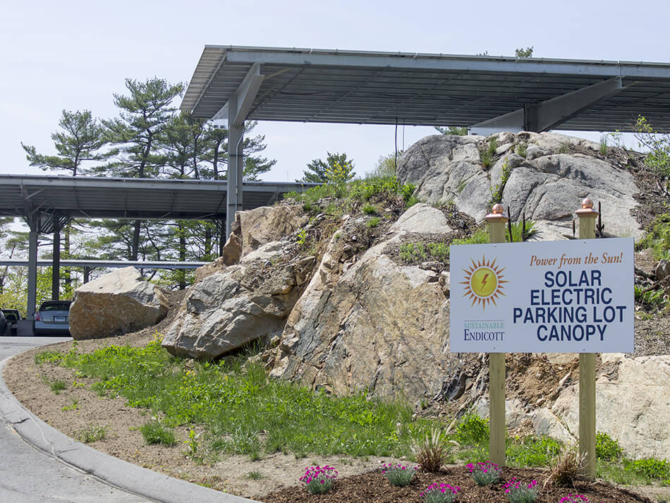 image of the sign for the solar parking and some of the awnings in the background