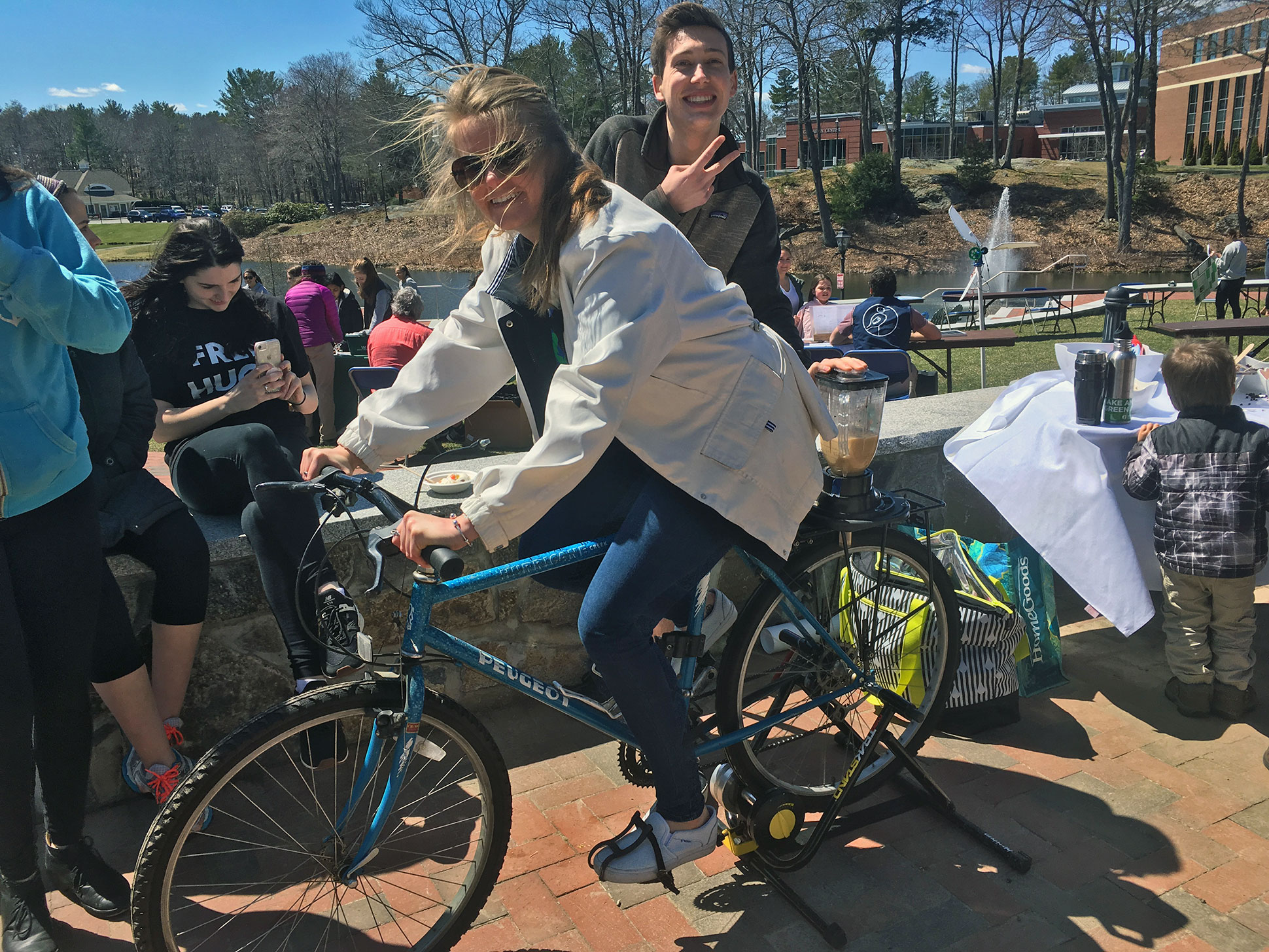 Staff member using the smoothie bike at the Earth Day Festival