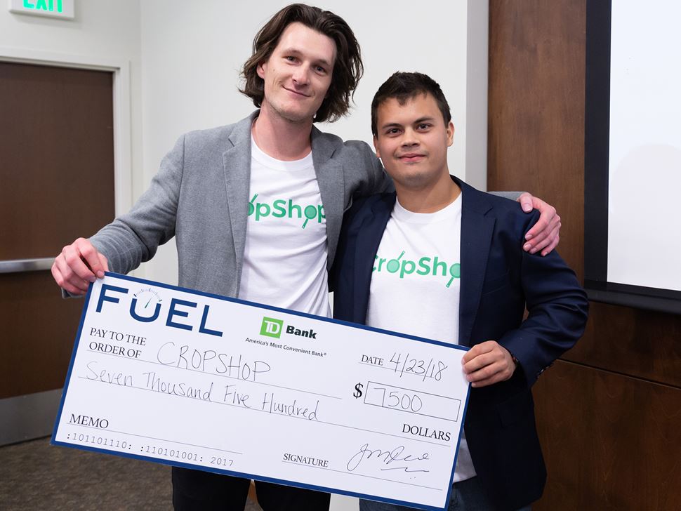 Two Endicott Students  holding a check that they were presented for each of their entrepreneurship entries
