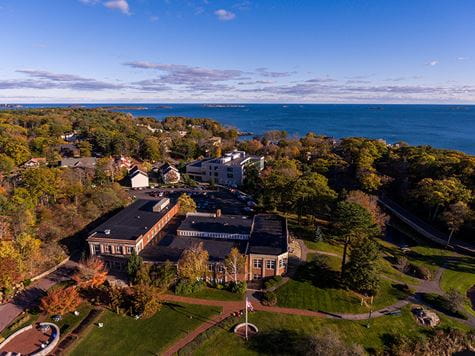 scenic aerial shot of part of campus with ocean on horizon