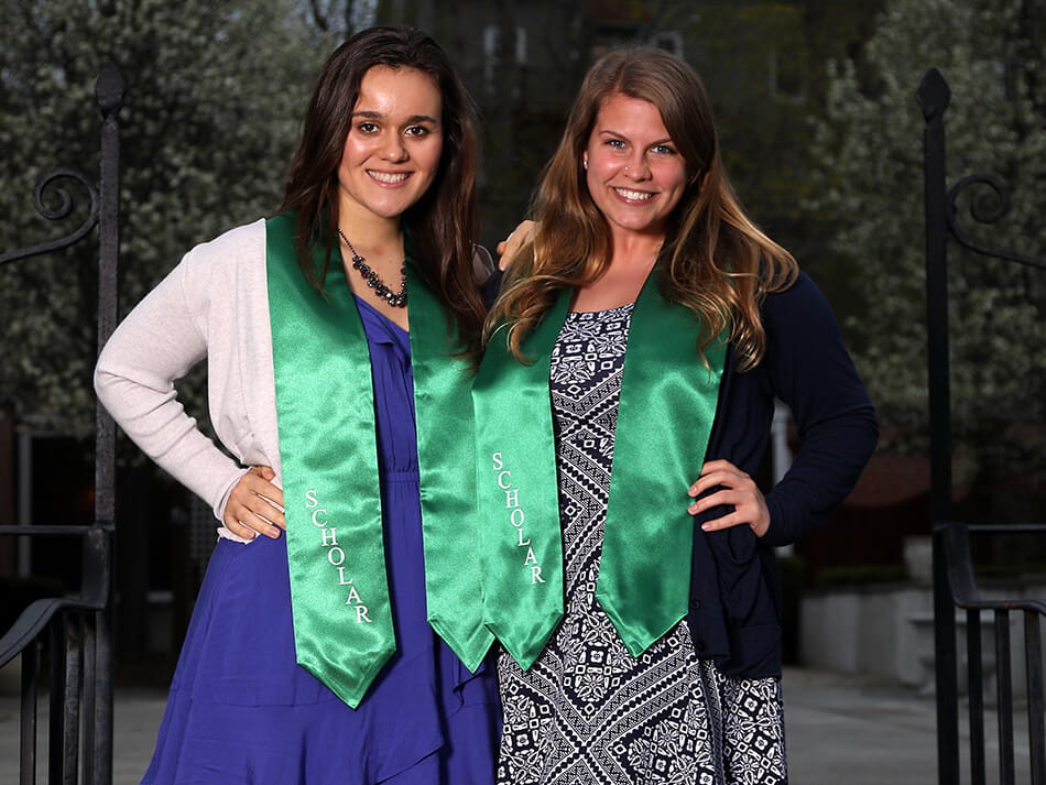 two students at honors gala wearing their honors sashes