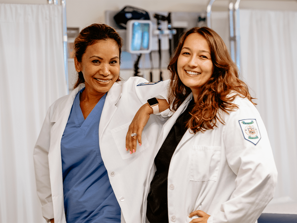 Nursing program image of two women posing in lab coats