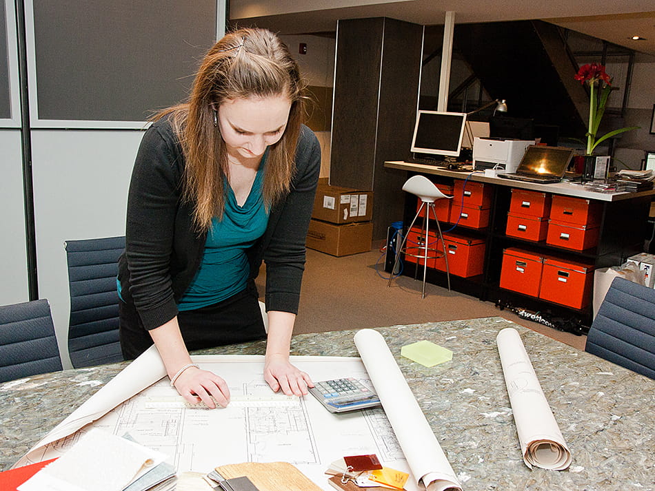 Endicott Architectural Studies Program student looking over blueprints