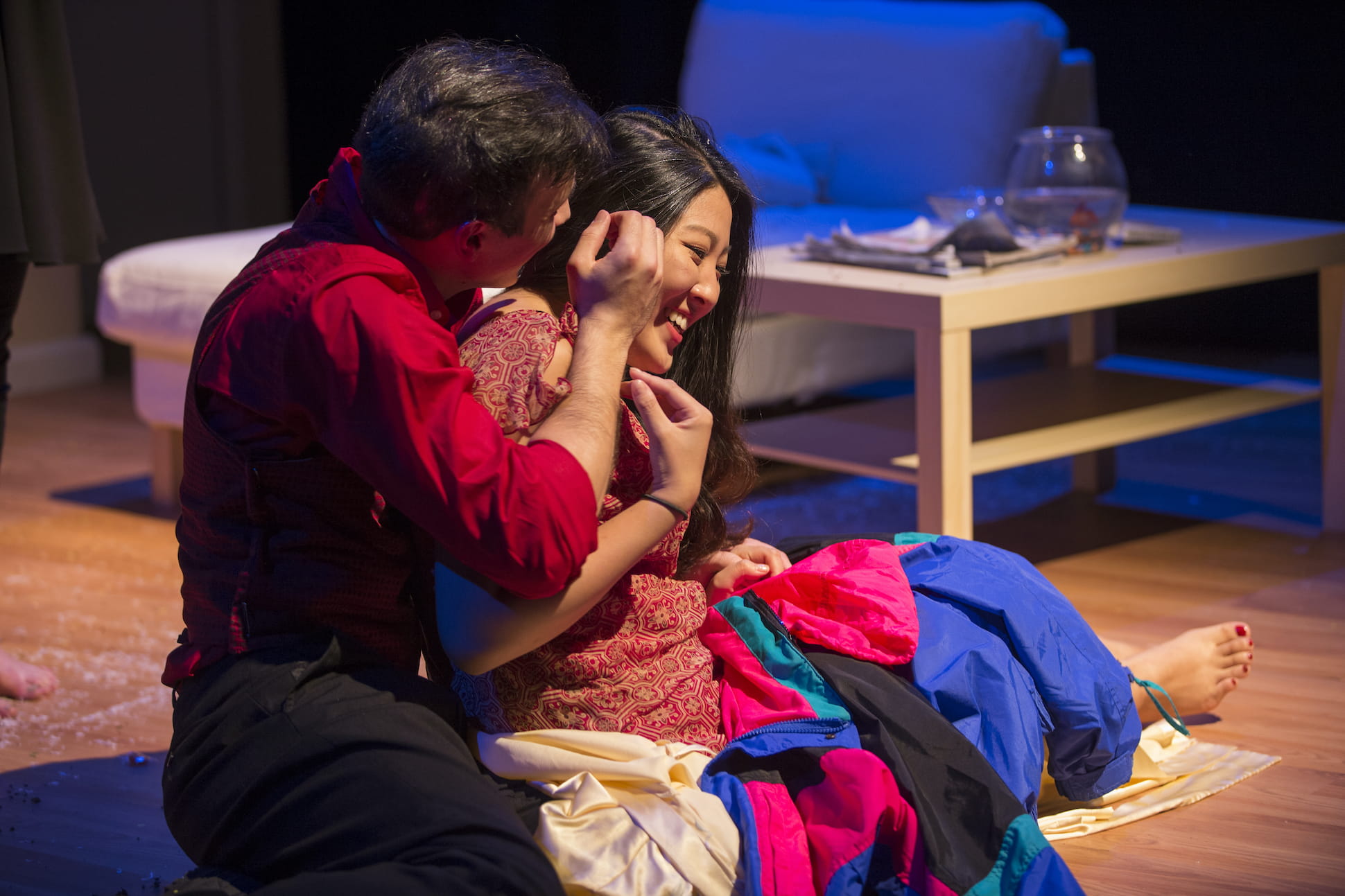 two actors embraced on the stage floor during a performance