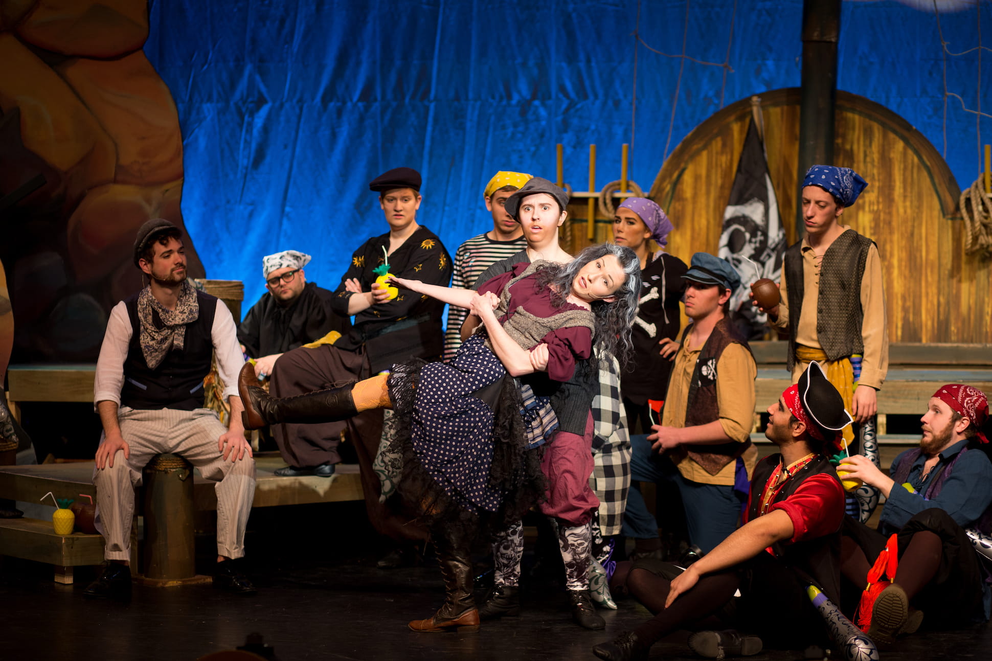 group of actors as pirates carrying one actress across stage