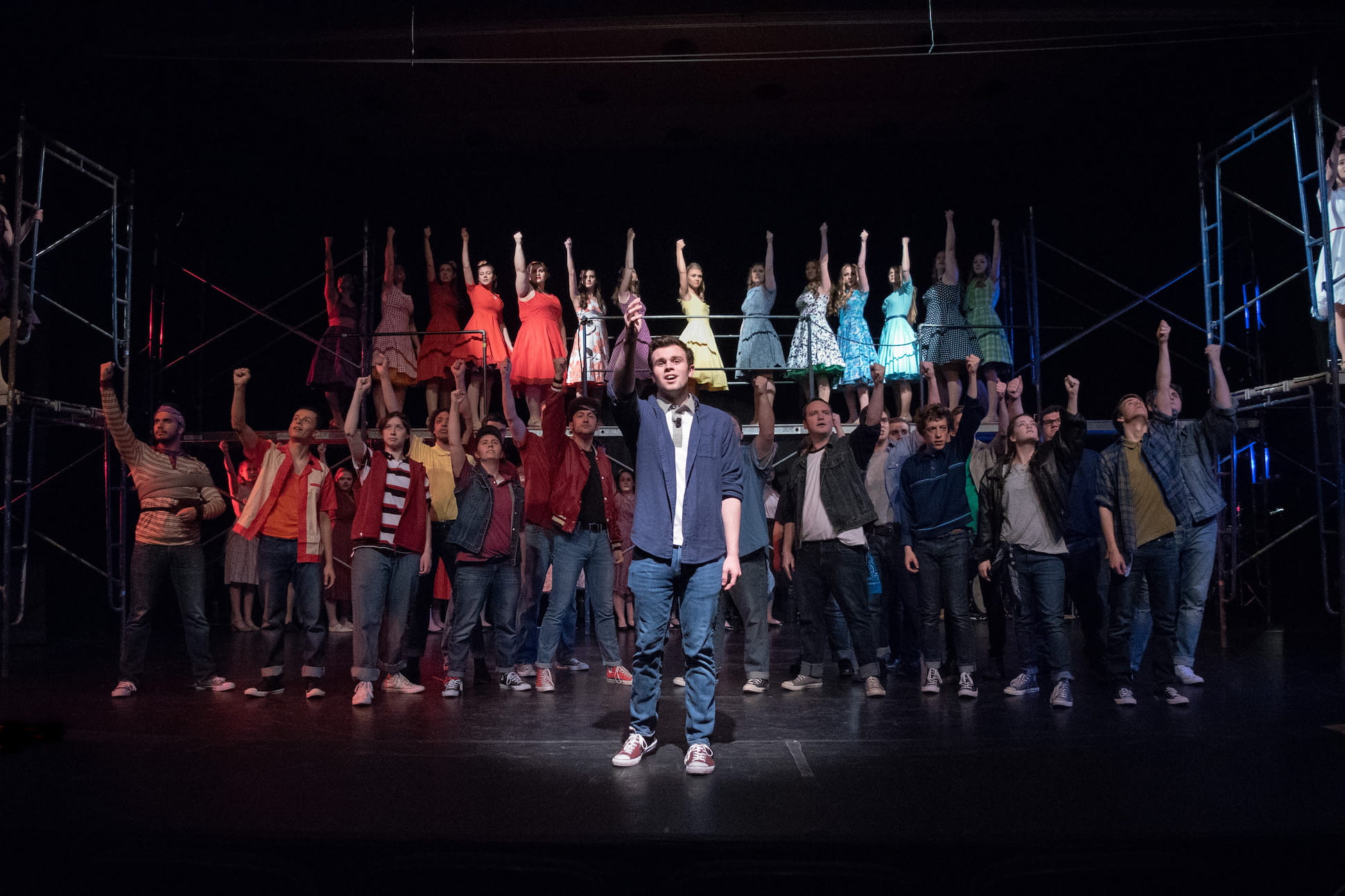 cast of play stands at attention for applause at end of show