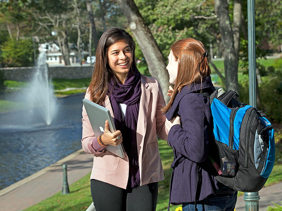 Two female students talking next to Endicott lake