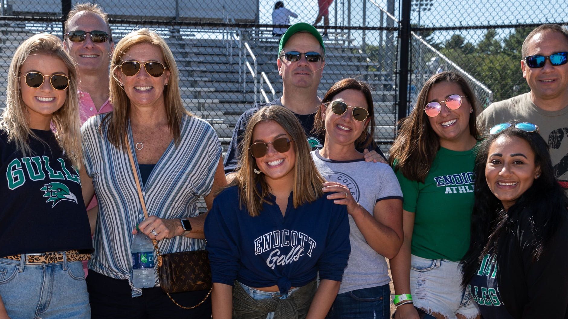 A group of alumni and families pose during Homecoming & Family Weekend