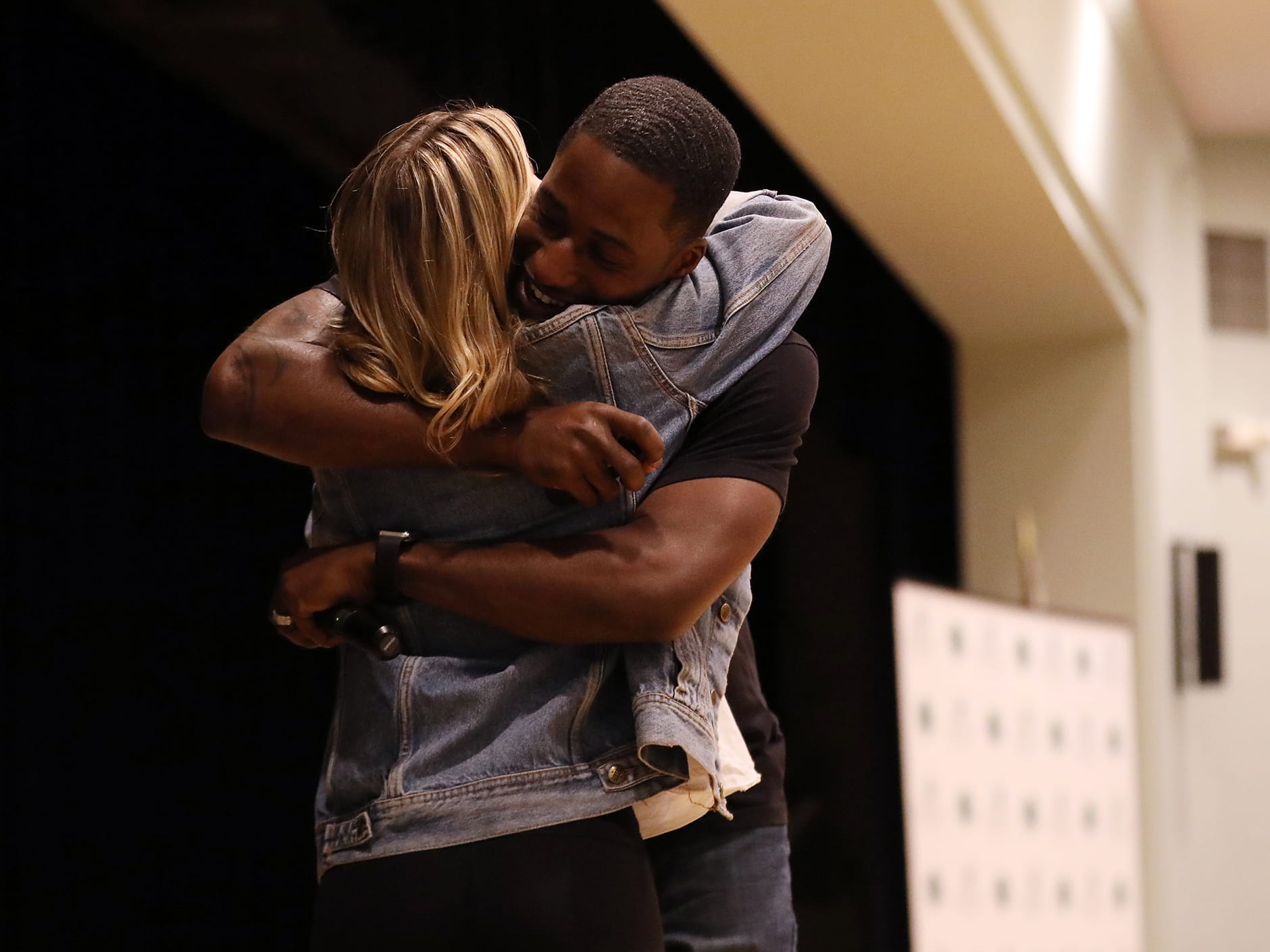 Ken E. Nwadike Jr., founder of the Free Hugs Project, gives a hug to a student as part of his message of peace.