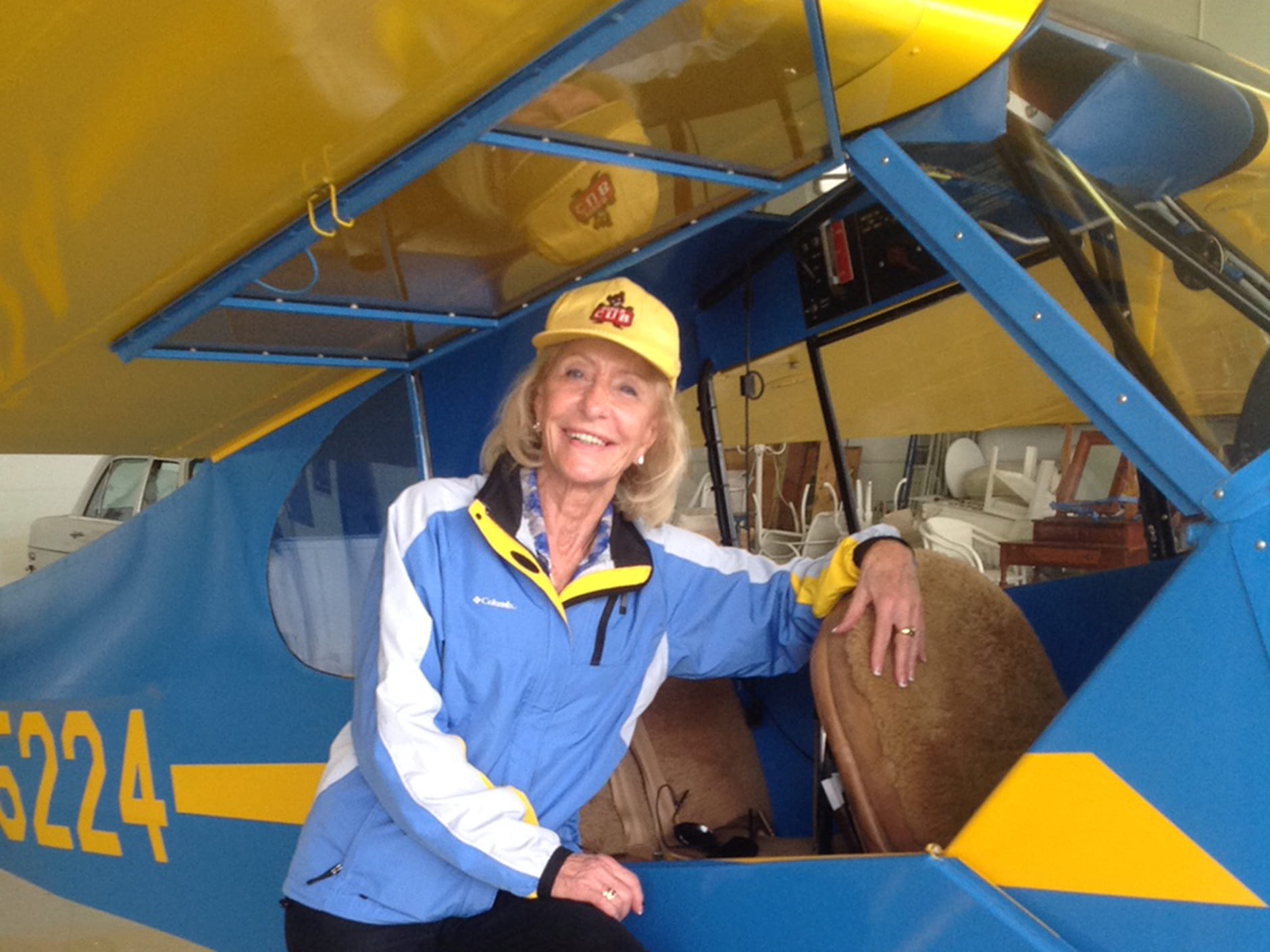 Myrt Harper Rose, a former wing-walker, leaning on a plane.