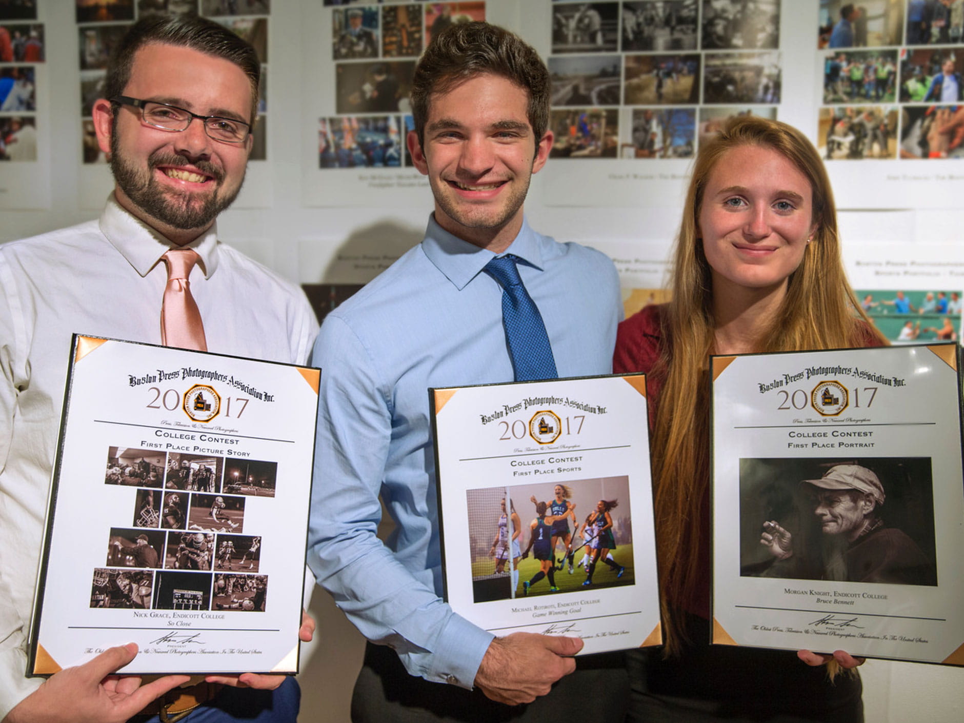 three student winners of the Boston Press photography contest display their plaques 
