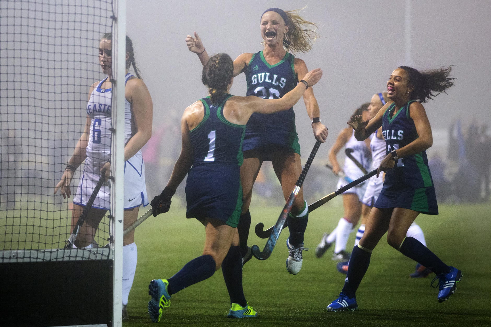 Endicott's Emily Wood (20) leaps in celebration after scoring the game-winning goal against the University of New England in field hockey action at Endicott college, Beverly, Mass. The final score was Endicott 2 and UNE 1.