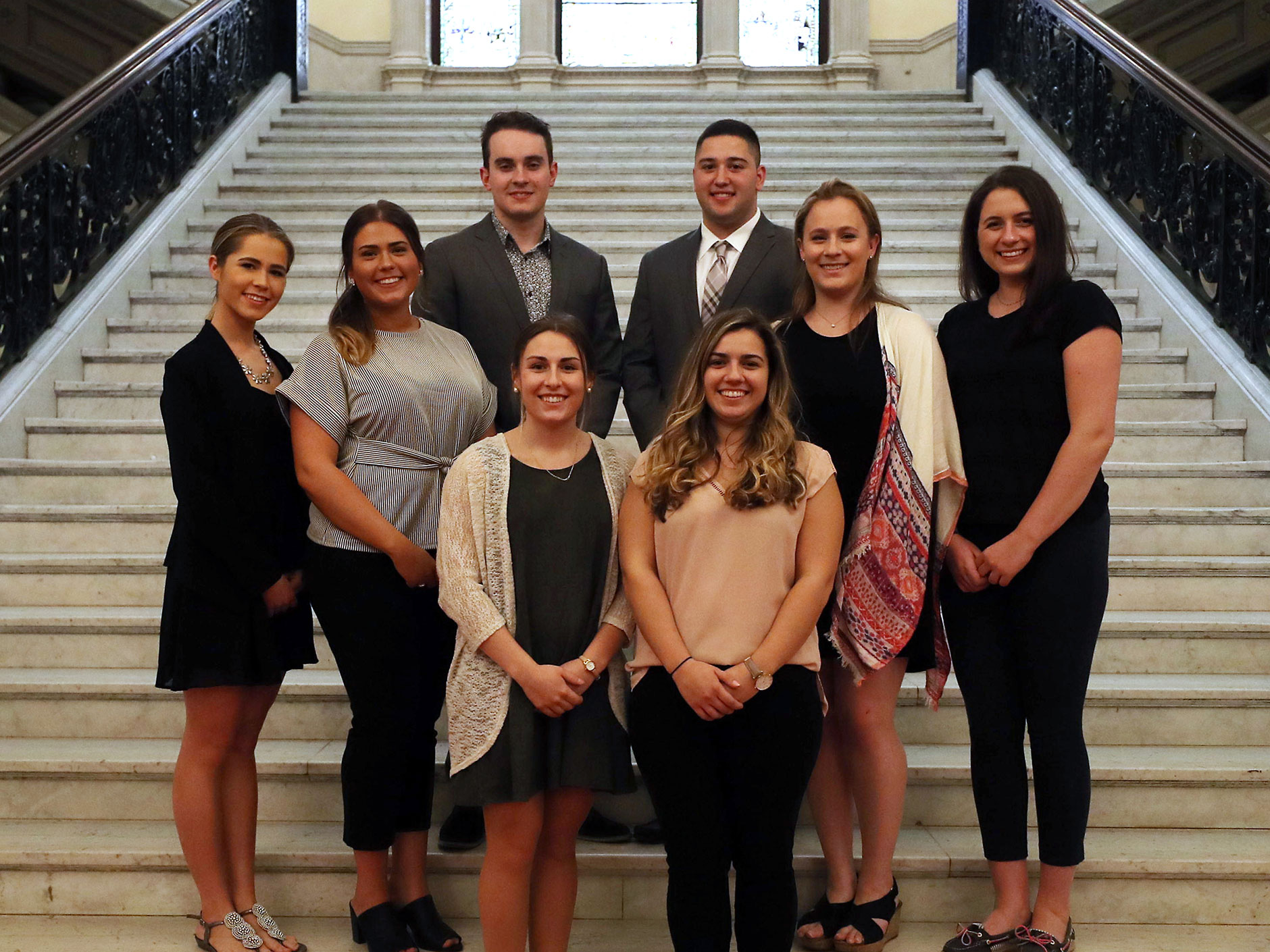Campaign Planning Students stand on the stairs of the State House. 