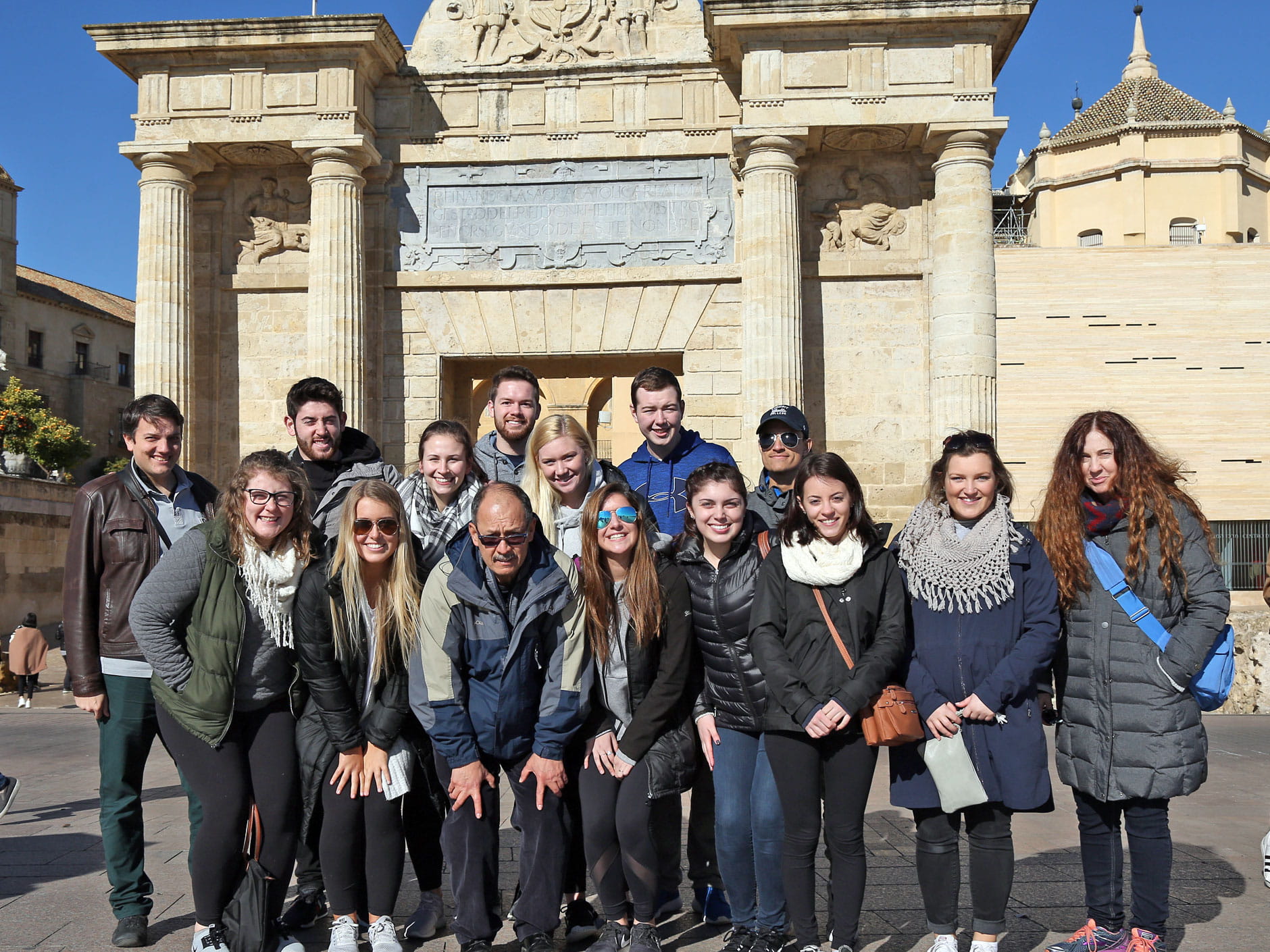 a group of students pose in front of a monument in Madrid, Spain 