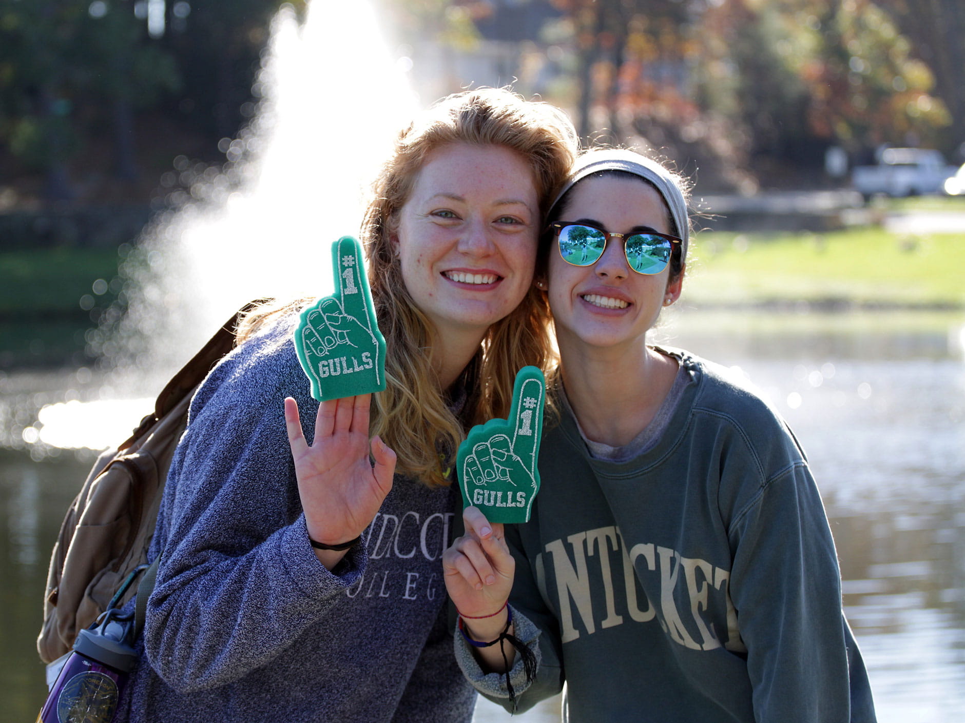 Two students holding up #1 foam fingers at last year's Homecoming and Family Weekend 2017. 
