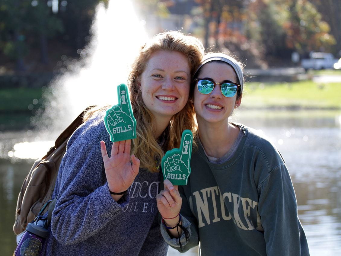 Two students holding up #1 foam fingers at last year's Homecoming and Family Weekend 2017. 