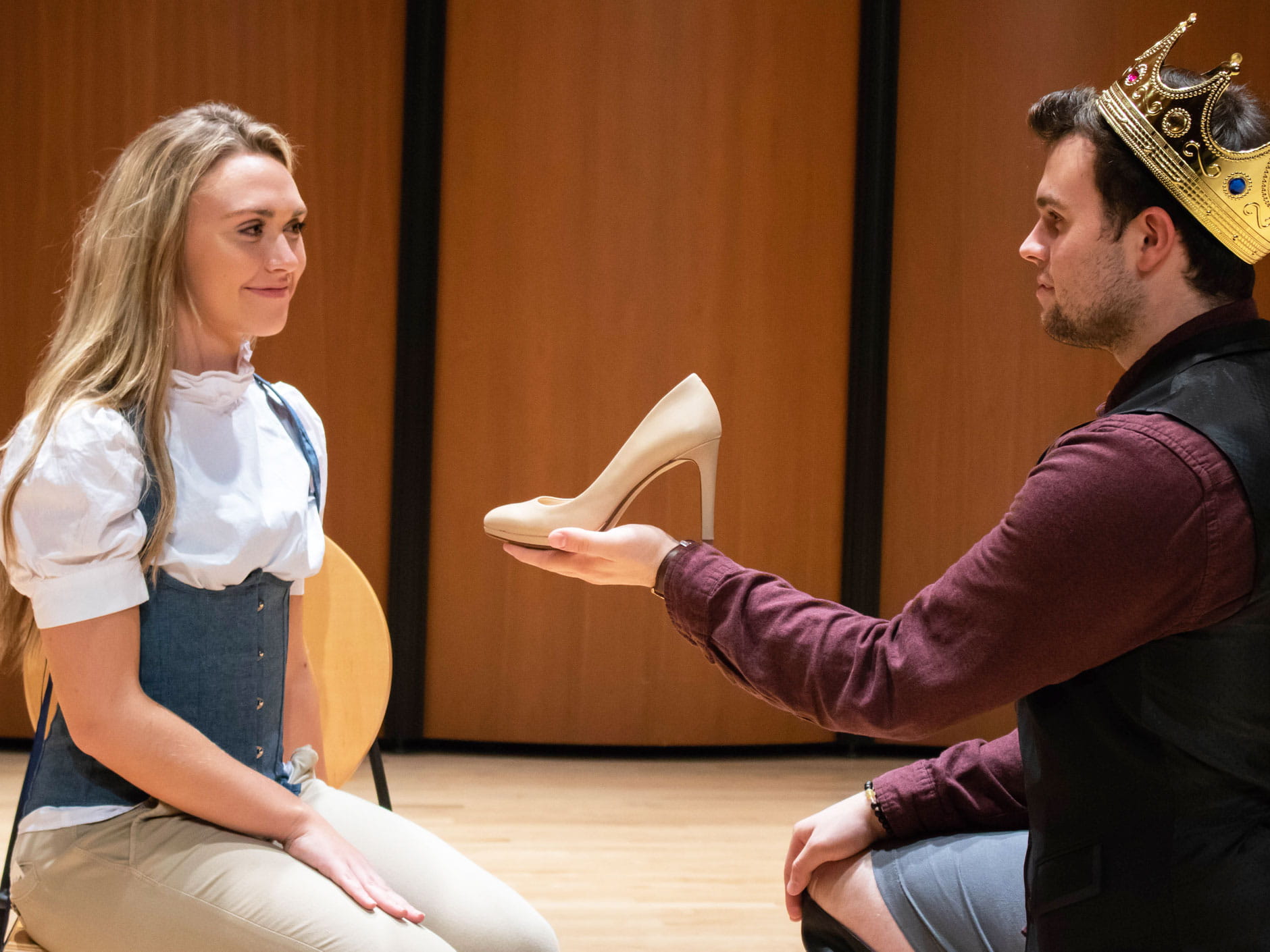 Two actors perform a scene from Into The Woods. Cinderella (played by Meaghan DelGenio) is presented her missing slipper by the proud Prince (Michael Varno). Photo credit: Nicole Sigrist
