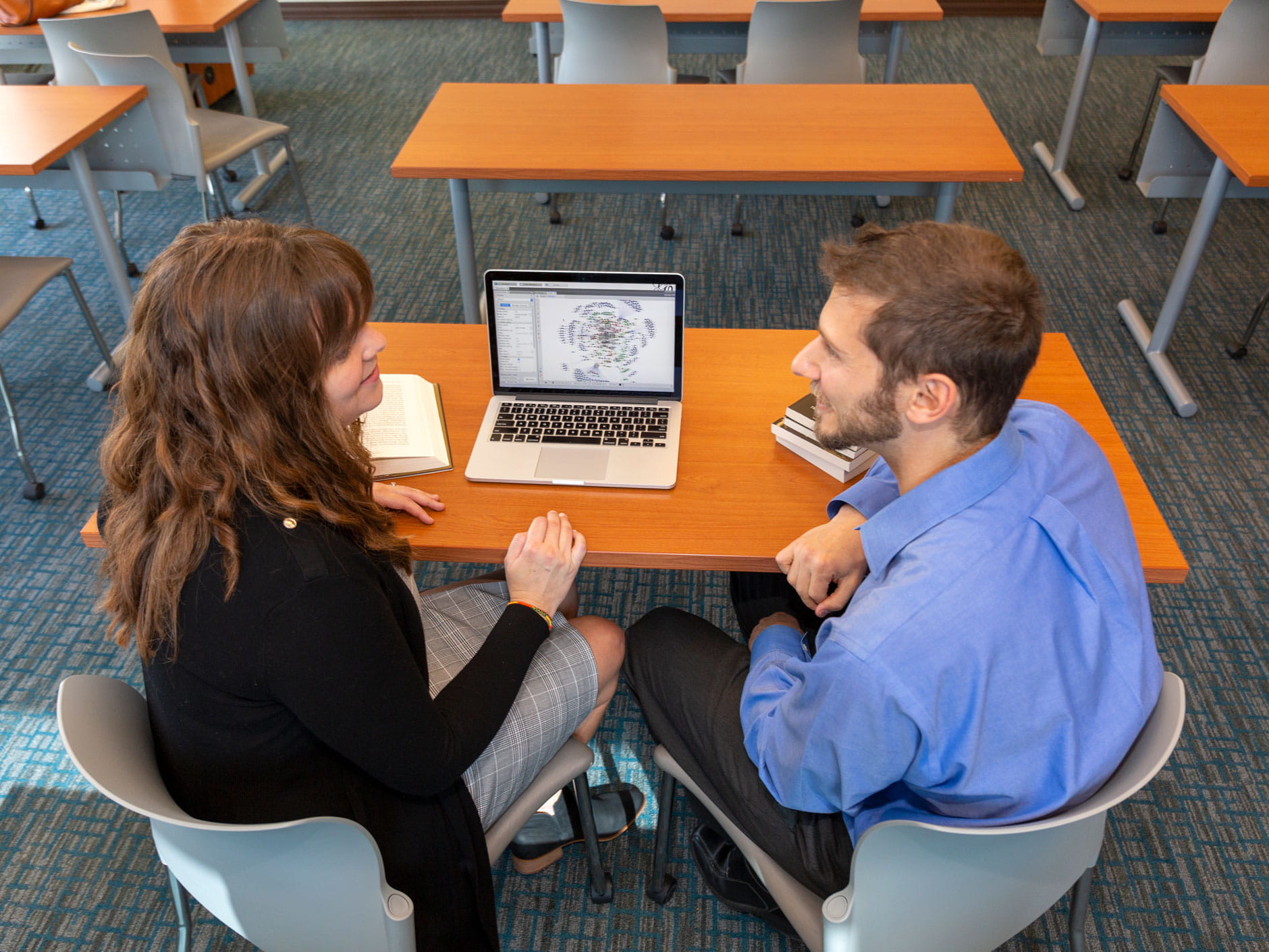 Professors Elizabeth Matelski and Philip Lombardo working at a table