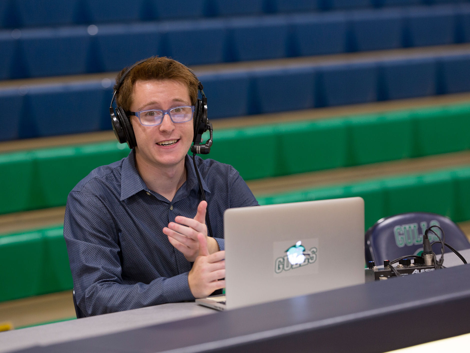 Zach Weiss '18 broadcasting at a scorer's table