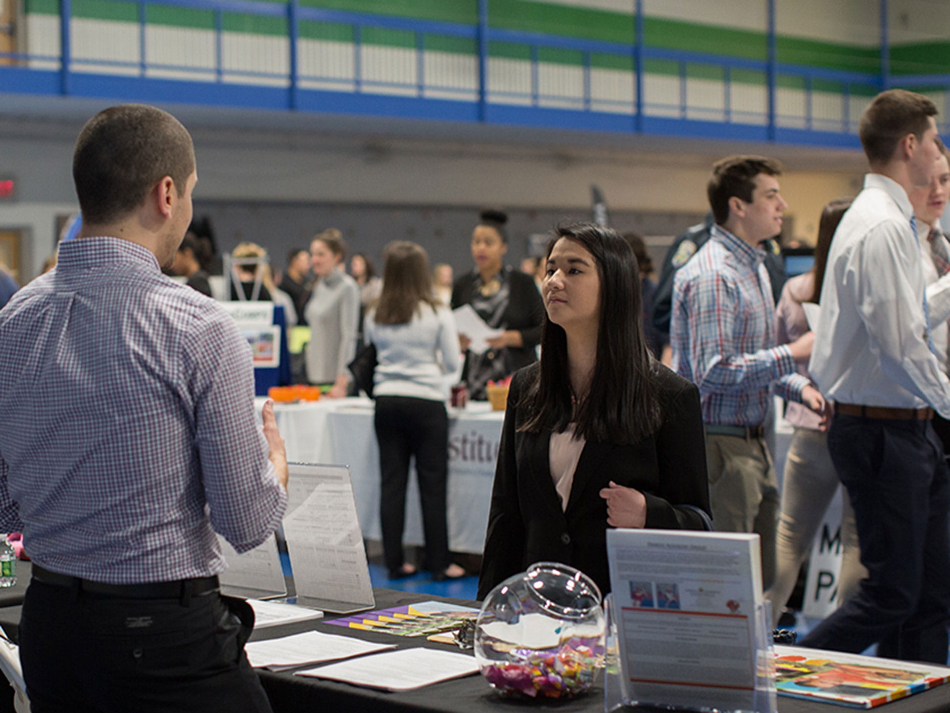 Student engaging with employers at internship fair. 