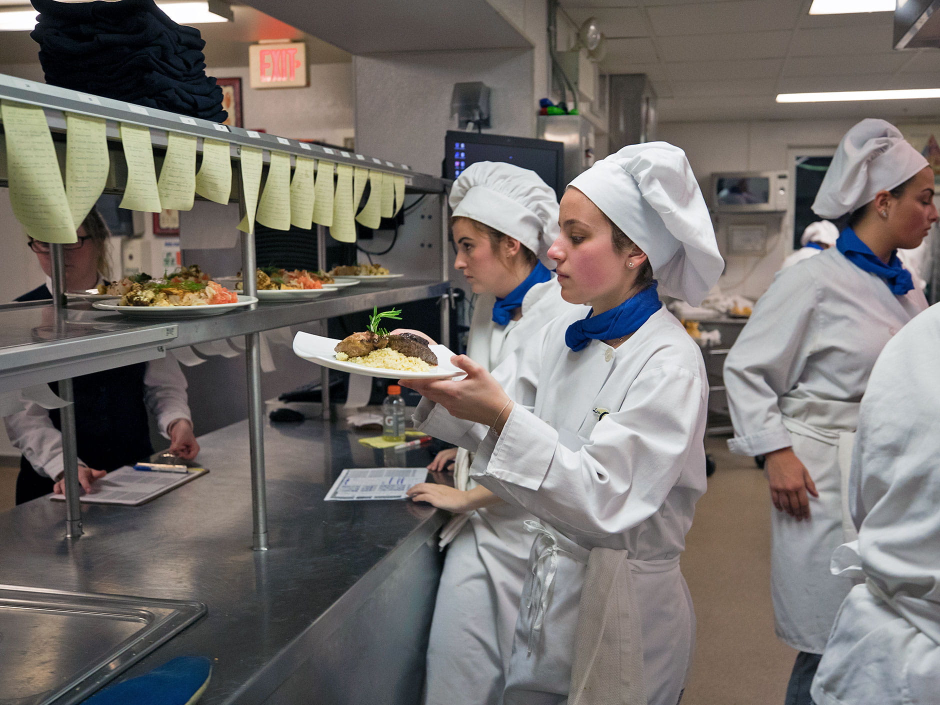 Students working in the kitchen at La Chanterelle