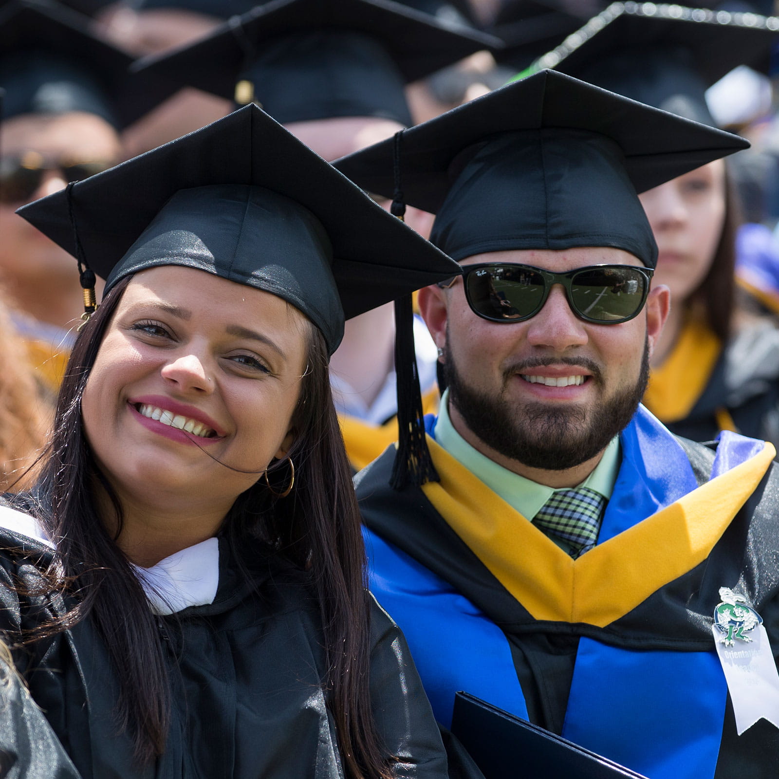 Two graduates smiling at the camera
