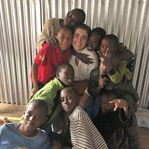 Emma Roca '21 posing with a group of students she taught in Africa