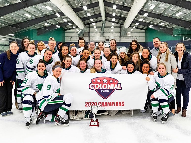 Women's hockey posing with their CHC championship trophy