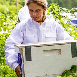 Endicott's Kate Chroust carrying beehives