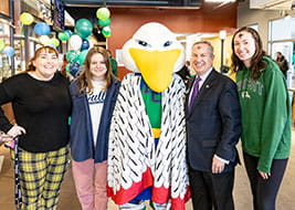 Students and Dr. DiSalvo pose with the Gull mascot