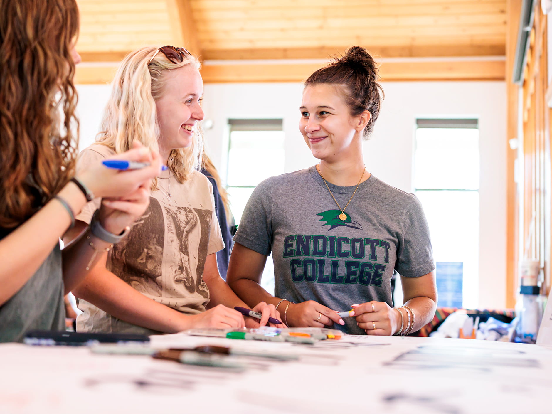 Students doing activities and smiling inside the Center for Belonging