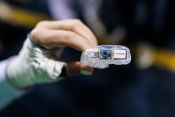 Someone holding a mouthguard