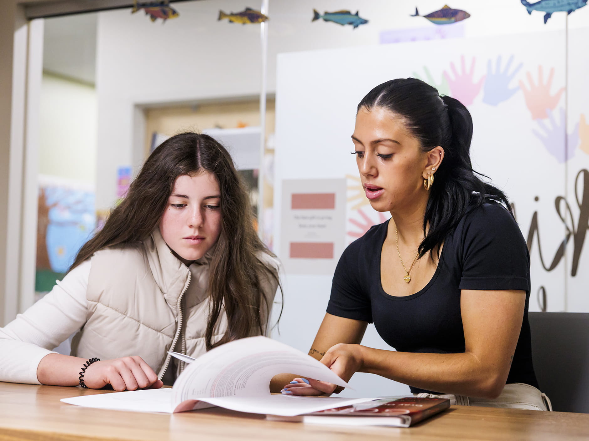 A younger student and a school counselor working together