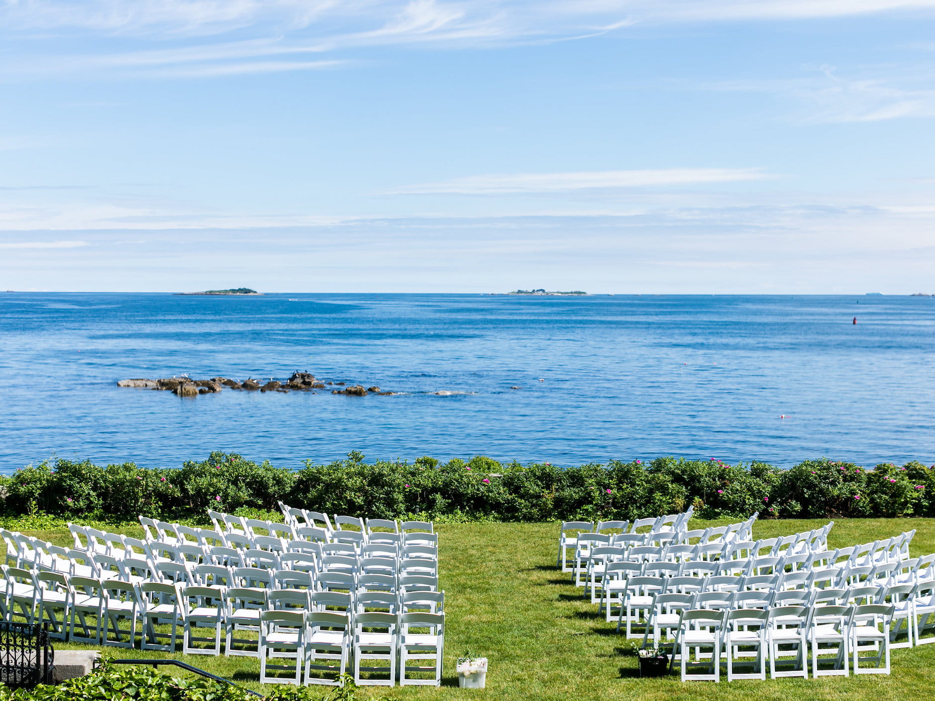 Chairs arranged for a seaside wedding at Misselwood Estate at Endicott College