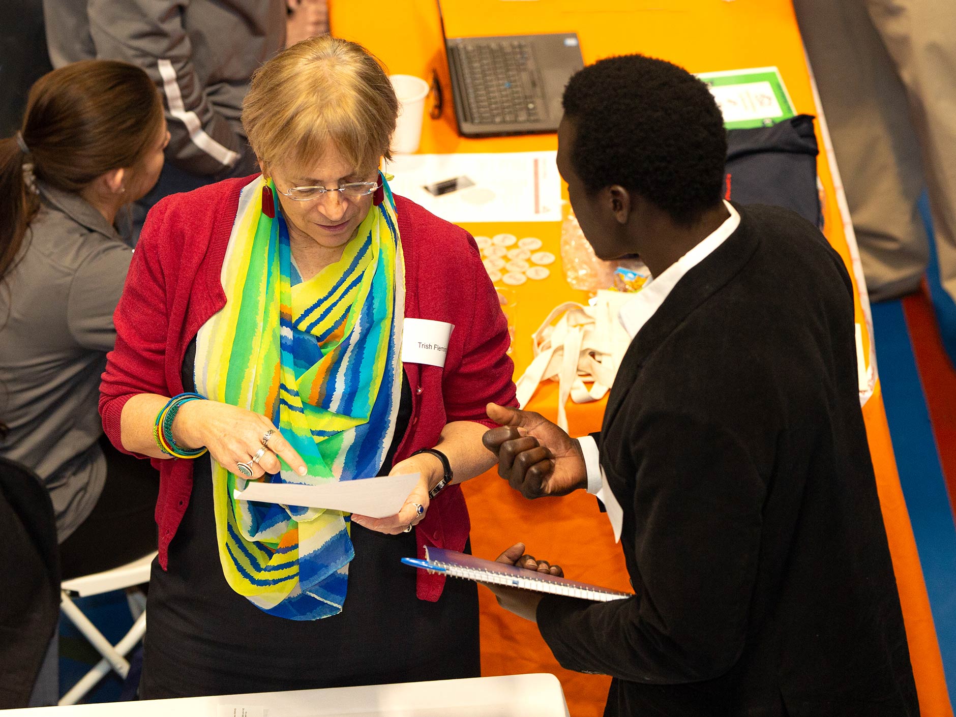 Aerial view of Endicott Career Fair with student and employer having a discussion