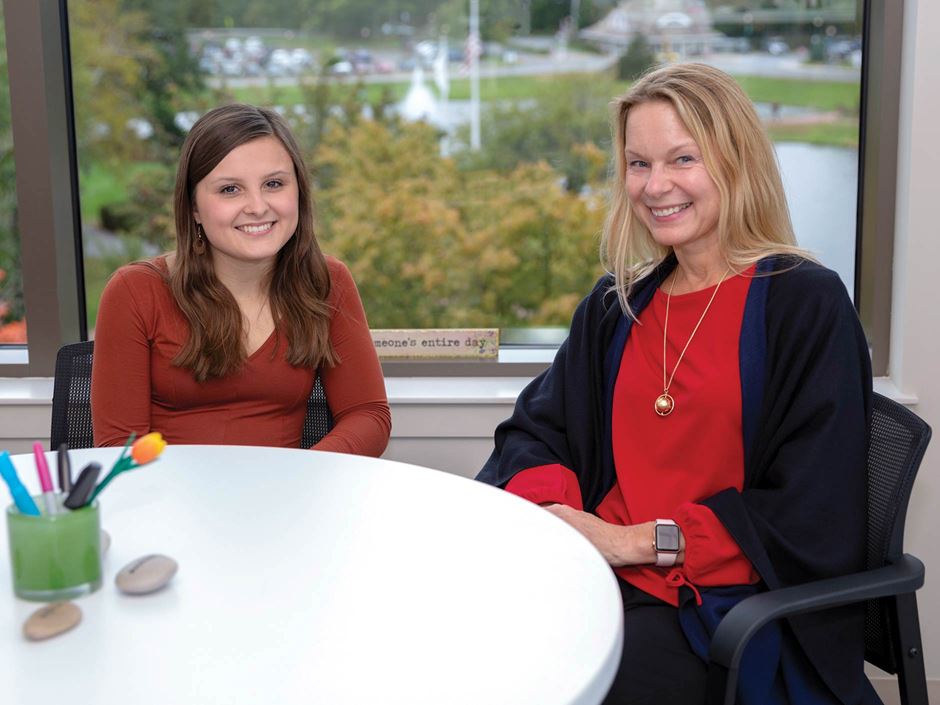 Endicott Scholars Colby Yokell and Dean Sara Quay sit at a table
