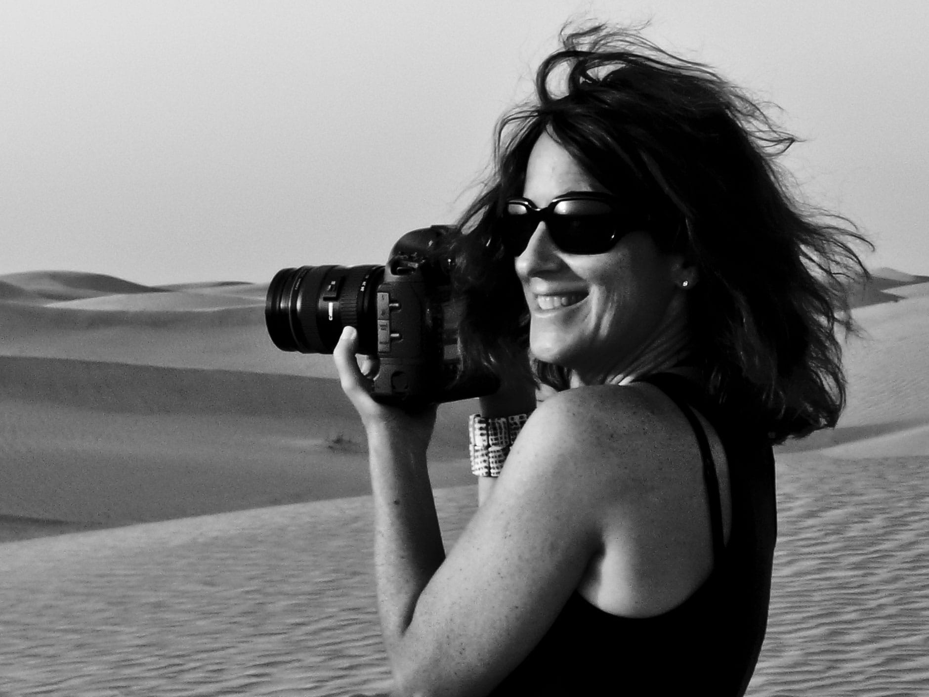 Stephanie Pfriender Stylander ’80 holding her camera, black and white photo