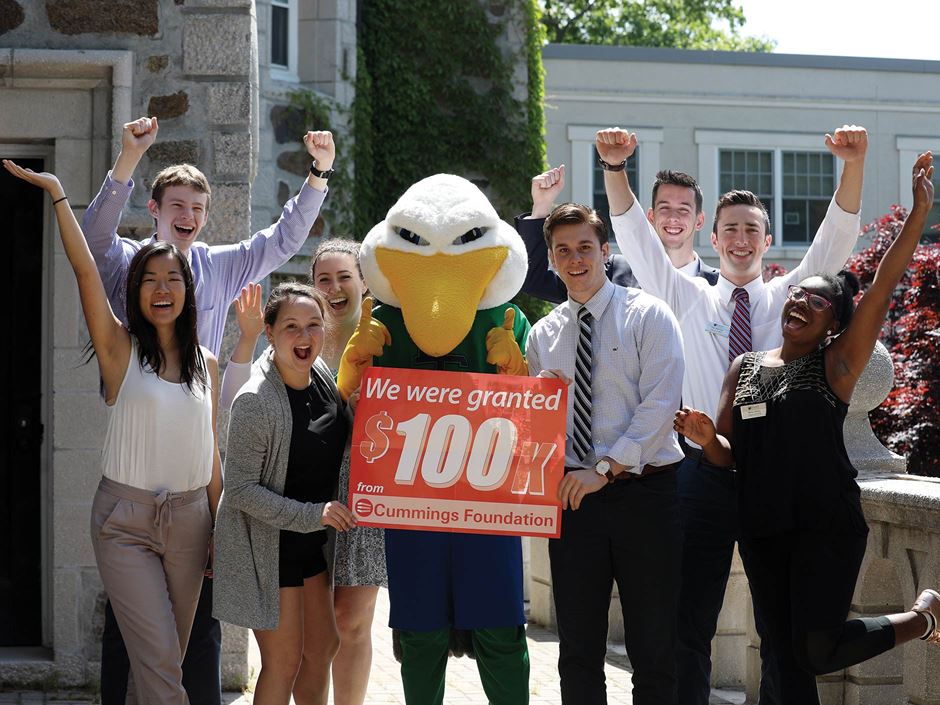 Endicott students and the Gull with a $100K for 100 program sign