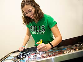 girl with pinball machine