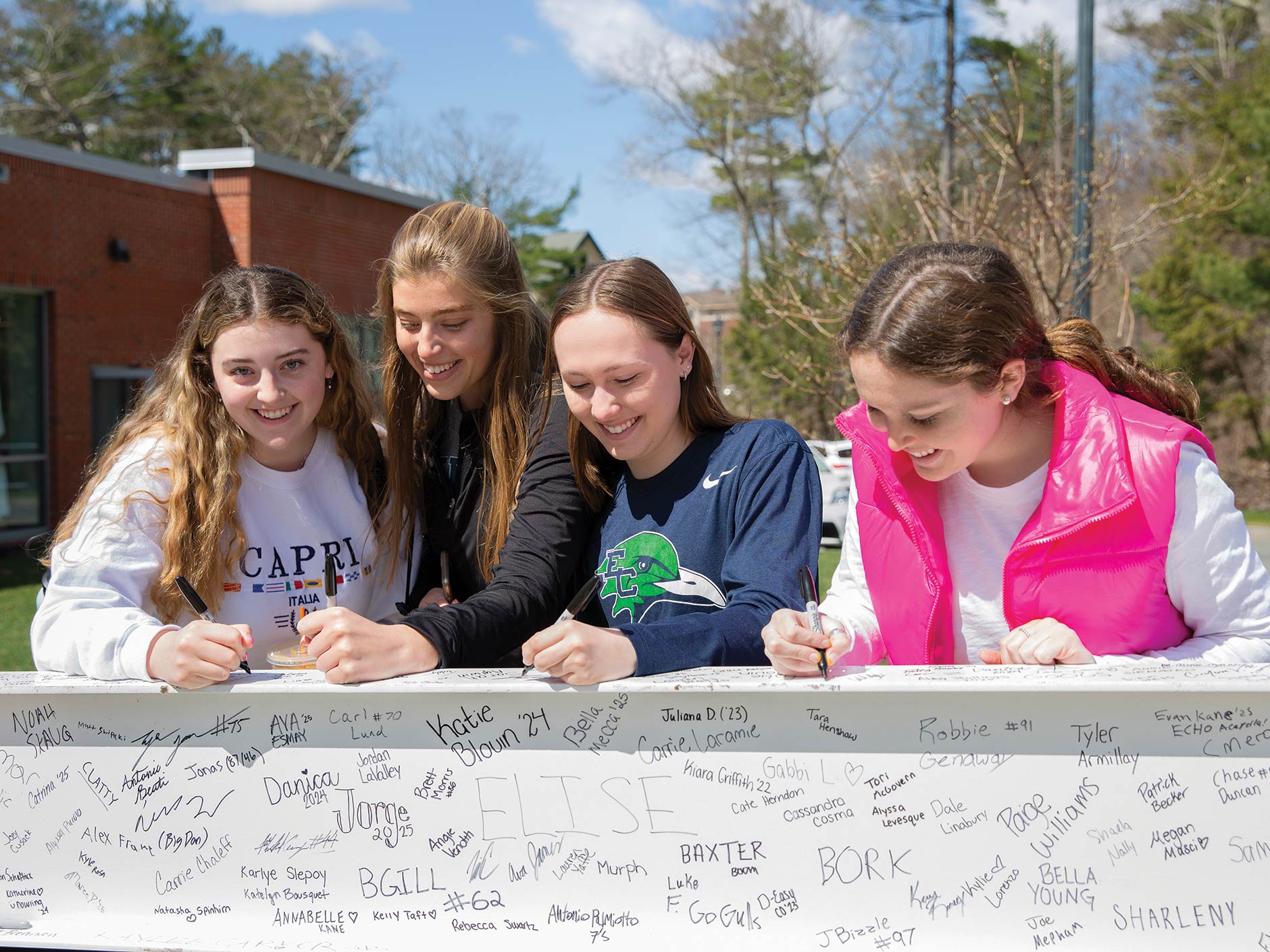 Signing a beam for the new Cummings School of Nursing & Health Sciences