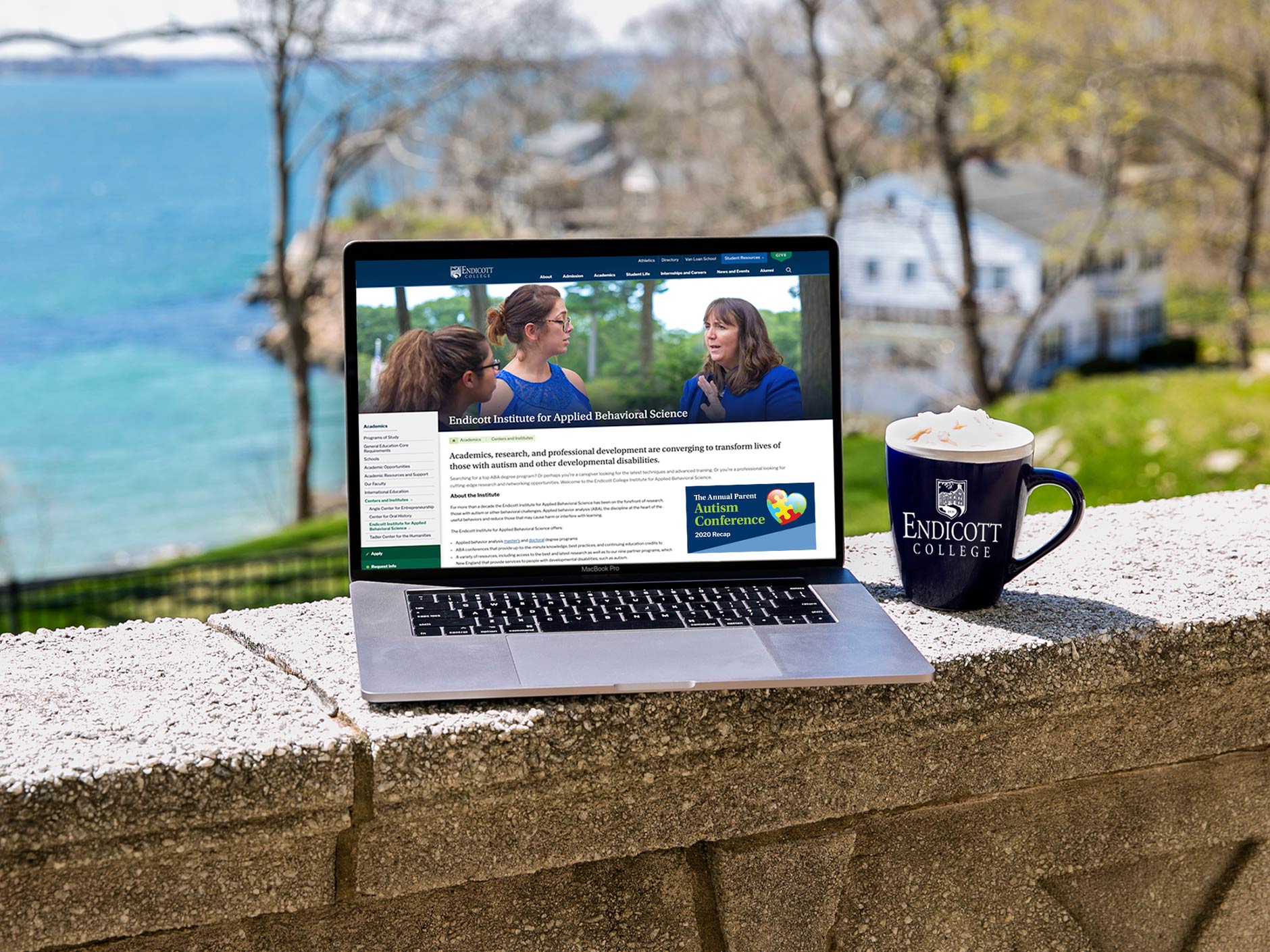 Laptop and coffee mug overlooking the water on Endicott College campus