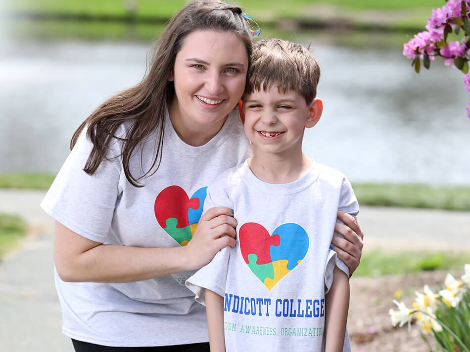 student working with autistic child in autism program