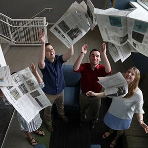 endicott observer staff throwing newspapers up into the air