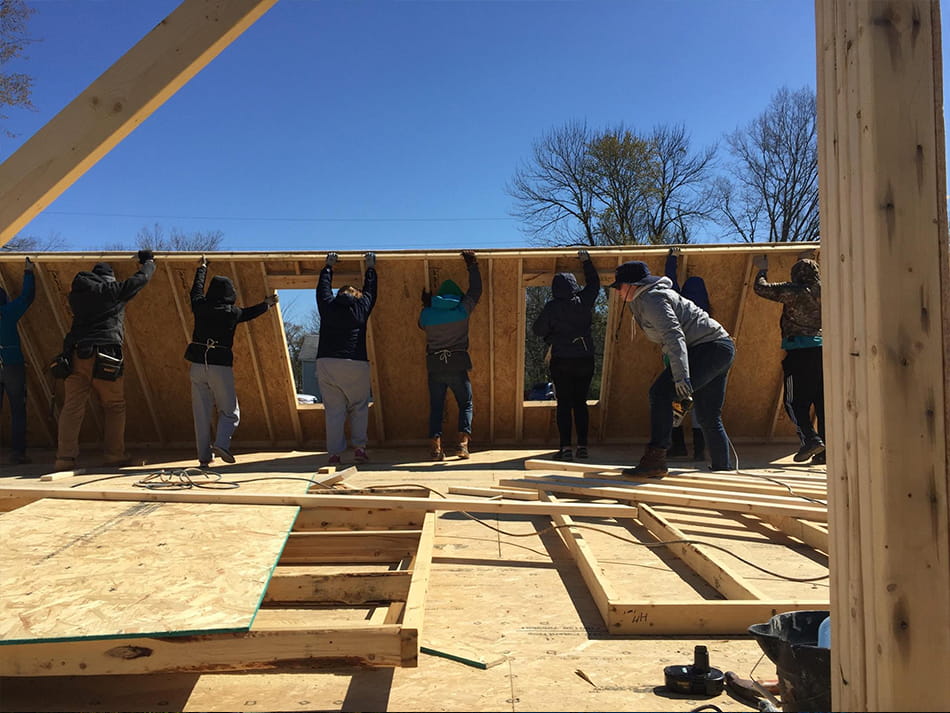 students working together to help build a house