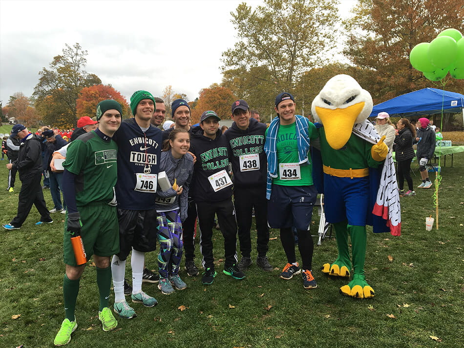group of people standing with endicott gull mascot during volunteer event